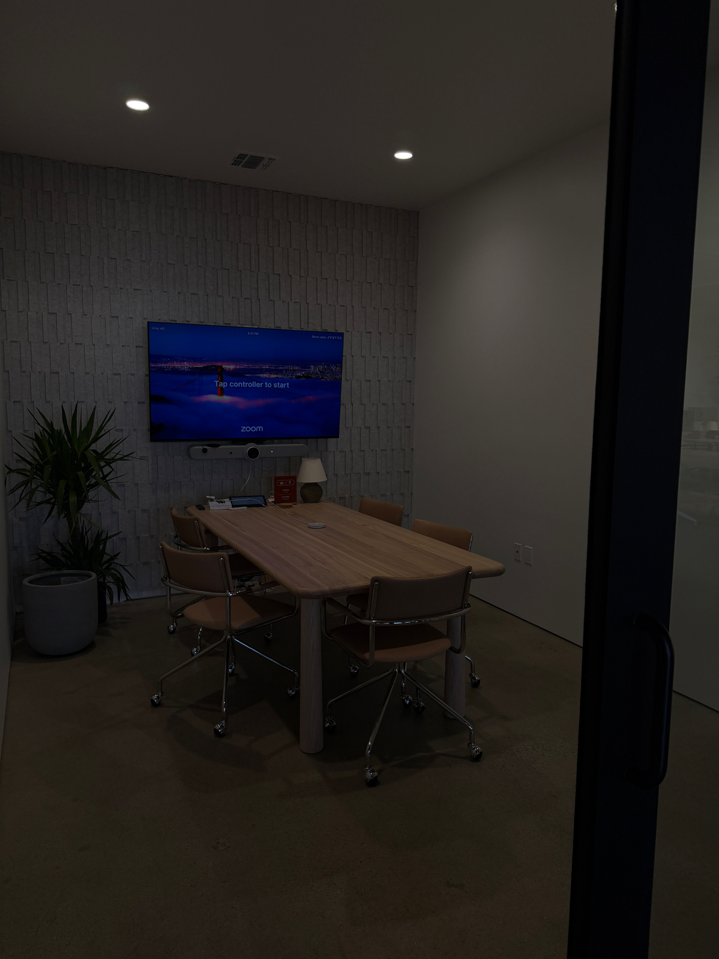 Conference room at Intro with textured wall, custom oak table and glass partition
